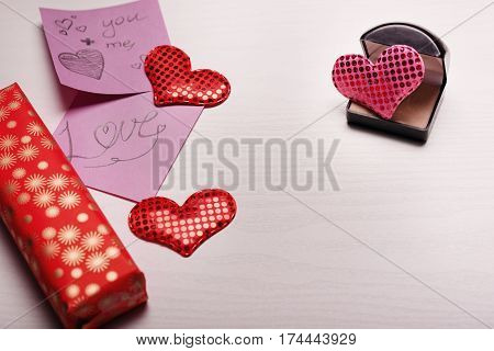 Wooden White Background With A Branch Of Pine And Three Hearts.