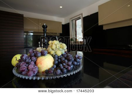 dish with fruit on kitchen table