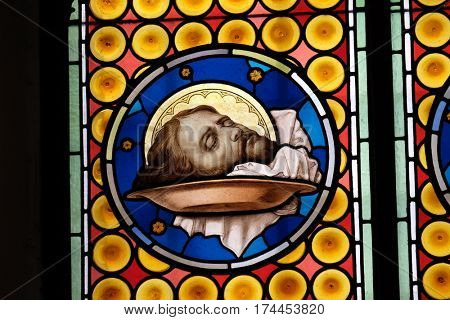 ROME, ITALY - SEPTEMBER 03: The head of Saint John the Baptist, stained glass window in Basilica of Saint Sylvester the First (San Silvestro in Capite) in Rome, Italy on September 03, 2016.