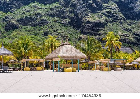 Le Morne Mauritius - December 11 2015: People are relaxing on the tropical Le Morne beach with coconut palms one of the finest beaches in Mauritius. Le Morne Brabant mountain in the background.