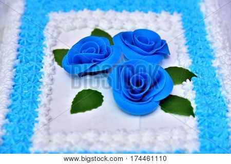 Cute delicious wedding cake decorated with cakes in the shape of red and white roses on the sides decorated with various beads and lines