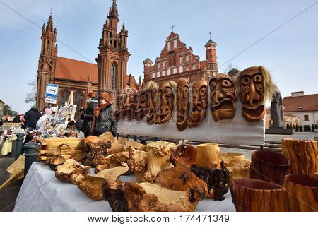 VILNIUS LITHUANIA - MARCH 4: Unidentified people trade traditional wooden masks in annual traditional crafts fair - Kaziuko fair on March 4 2017 in Vilnius Lithuania