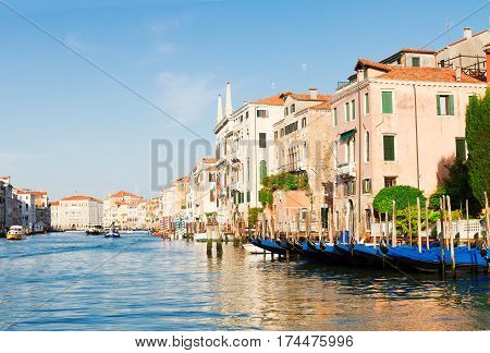 colorful traitional Venice gondola boats and houses over water of Grand canal, old town of Venice, Italy