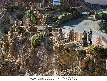 Almeria Spain: December 23 2016: Tourists enjoying beautiful view of Las Sirenas in the Cabo de Gata-Nijar Natural Park. South-eastern corner of Spain