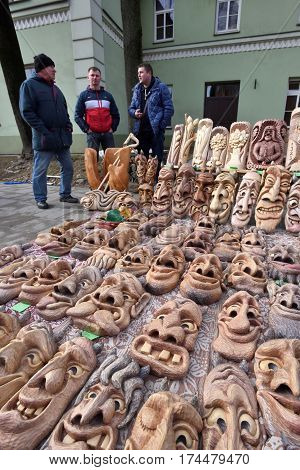 VILNIUS LITHUANIA - MARCH 4: Unidentified people trade traditional wooden masks in annual traditional crafts fair - Kaziuko fair on March 4 2017 in Vilnius Lithuania