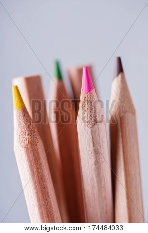 group of sharpened colorful pencils on light background. Wooden pencils. Natural materials. School and education. Drawing and painting.