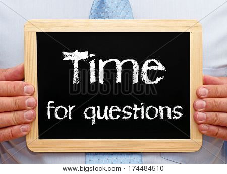 Time for questions - Businessman holding chalkboard
