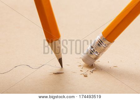 pencil draw a wavy line on paper and pencil eraser removing stripe. Business Breaking concept. Writing. Concept. School and education.