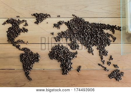 World map made from roasted coffee beans on wood backgrond