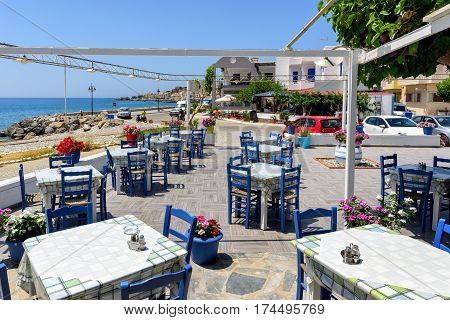 PALEOCHORA, CRETE, GREECE - JUNE 2016: Traditional Greek tavern near the beach of Paleochora town on Crete island, Greece