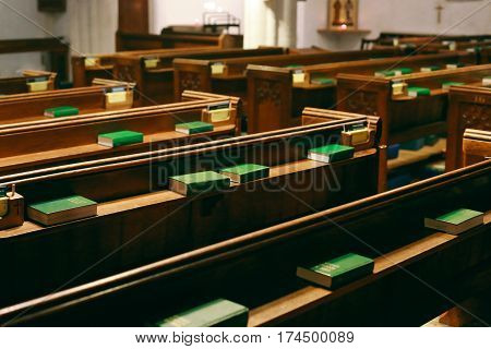 CAMBRIDGE, UK - JANUARY 1, 2017: Rows of wooden pews and books ready for mass in St Bene't's Church, the oldest church in Cambridgeshire as well as the oldest building in Cambridge.