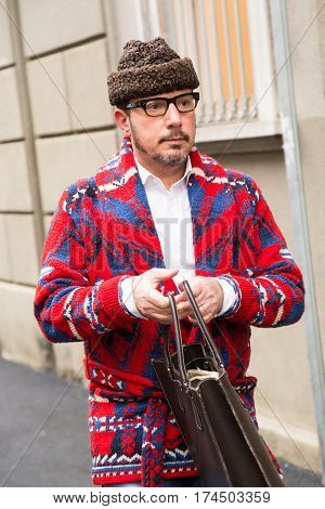 MILAN ITALY - FEBRUARY 23: Fashionable man poses outside Les Copains fashion show during Milan Women's Fashion Week on FEBRUARY 23 2017 in Milan.
