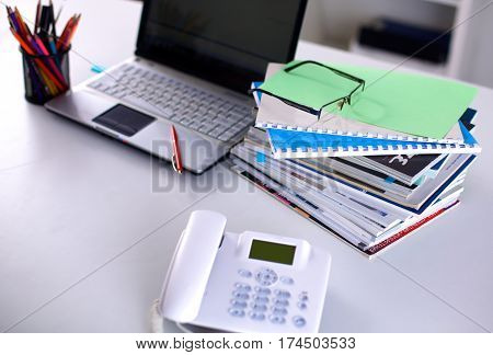 Group of multicolored office folders and glasses.