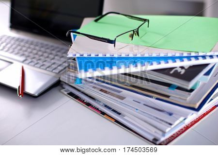 Group of multicolored office folders and glasses.