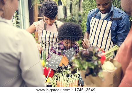 People Buying Vegetable From Shop at Market
