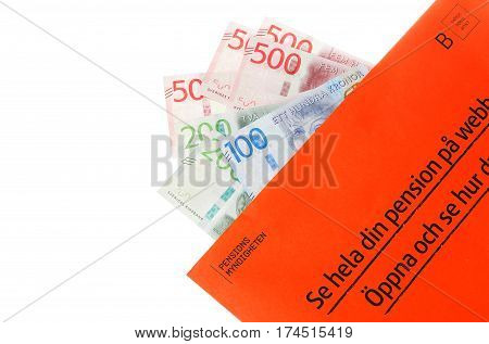 Stockholm Sweden - March 3 2017:The orange envelope from the Swedish Pensions Agency (Pensionsmyndigheten) with teh annual statement on top of Swedish banknotes.
