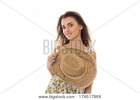 young cute girl holding hand hat and looks at the camera close-up isolated on white background