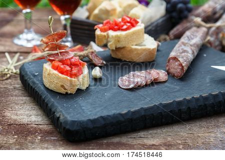 Making Pintxo With Tomato And Sausages, Tapas, Spanish Canapes Party Finger Food