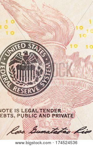United States Federal Reserve System symbol with torch from ten dollar bank note. Close up shot.