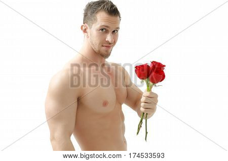 Handsome man holding a red rose and a bouquet of red roses. Sexy man gives a rose on a white background with a beautiful light. Isolated on white background