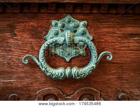 Ornate Brass Door Knocker On A Vintage Wooden Door