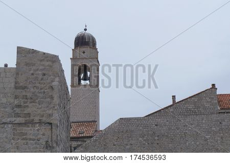 Clock tower built in 15 century in Stradun street in Dubrovnik, Croatia in gloomy evening