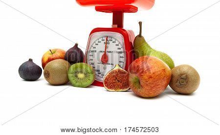 ripe fruit and kitchen scales on a white background. horizontal photo.