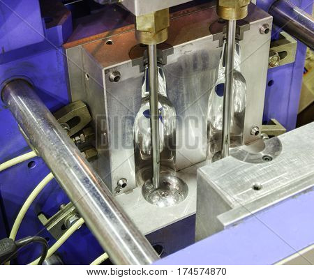Injection molds for PET bottles. The main working part of the machine blowing plastic bottles. Polished shiny surface.