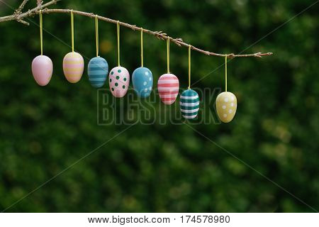 Easter eggs border on natural green background in natural light