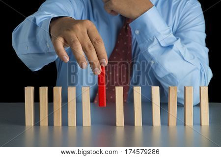 Businessman Hand Pick One Of Wood Block From Many Wood Block In Row, Metaphor To Business Concept In