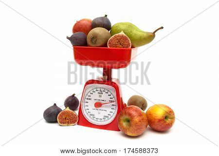 Fruit and kitchen scales isolated on white background. horizontal photo.