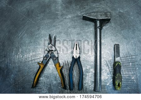 Top view of set working tools lying on metal table