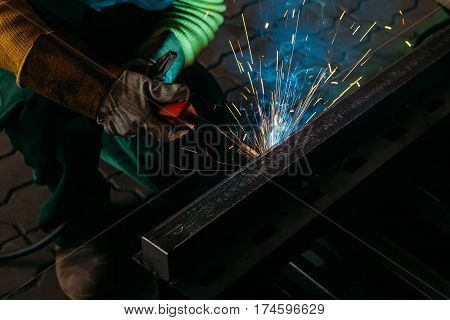 sparks while welder uses torch to welding industry