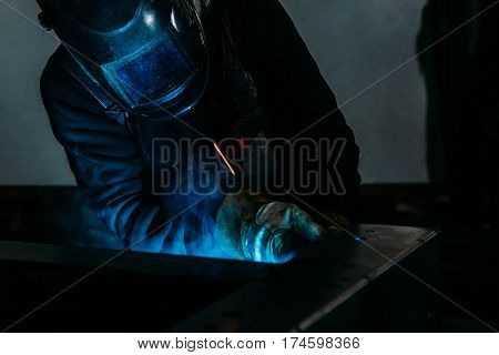 sparks while welder uses torch to welding industry