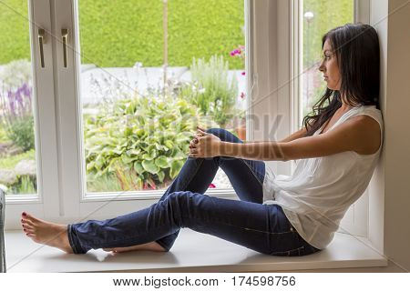 woman sitting on window