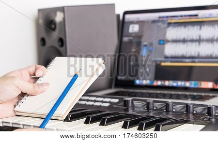Music song writer is working in his home studio
