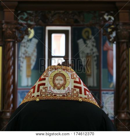 Orthodox bishop praying in front of altar