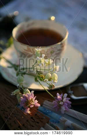 a cup of tea on the sunset light and pearl operaglasses
