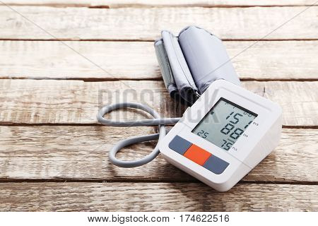 White Electric Tonometer On Brown Wooden Table