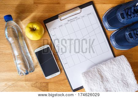Personal workout plan with sneakers, smartphone and other fitness stuff. Top view image