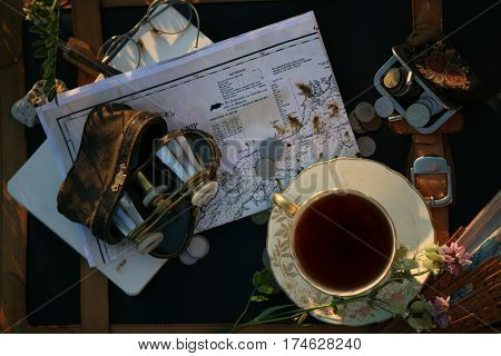 a cup of tea in the sunset light and pearl operaglasses