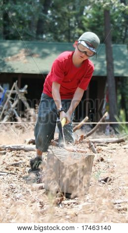 Young Boy Splitting Logs
