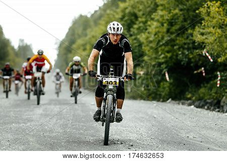 V.Ufaley Russia - August 09 2015: leader racer cyclist mountainbiker in front group of riders during bicycle race "Big stone"