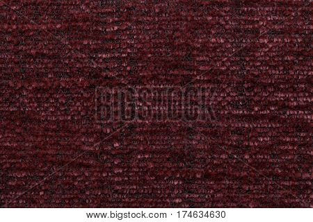 Dark red background of soft fleecy cloth. Texture of textile closeup.