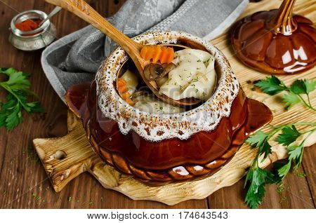 Meat dumplings with vegetables in pots. Rustic style