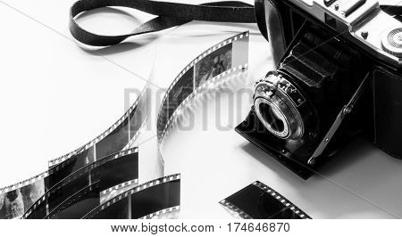 black and white photo of an old analogue camera displayed with negatives