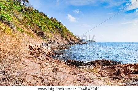 Beautiful seascape with rocks and meadow in cloudy blue sky at Khao Leam Ya National Park Rayong province Thailand