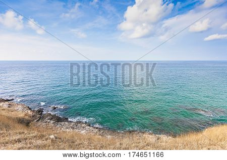 Beautiful seascape with rocks and meadow in cloudy blue sky at Khao Leam Ya National Park Rayong province Thailand