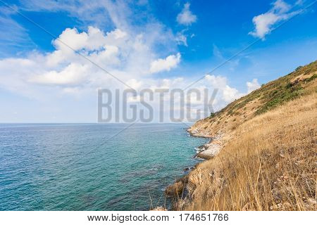 Beautiful seascape with rocks and meadow in cloudy blue sky at Khao Leam Ya National Park Rayong province Thailand