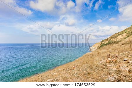 Beautiful seascape with rocks and meadow in cloudy blue sky at Khao Leam Ya National Park Rayong province Thailand